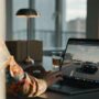 Laptop on a desk streaming an open world car chase action game inside a web browser.