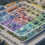 A 3D isometric overview showing organized zones and power lines in a simulation base.