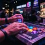 Hands resting on glowing arcade fight stick buttons during a Street Fighter match.